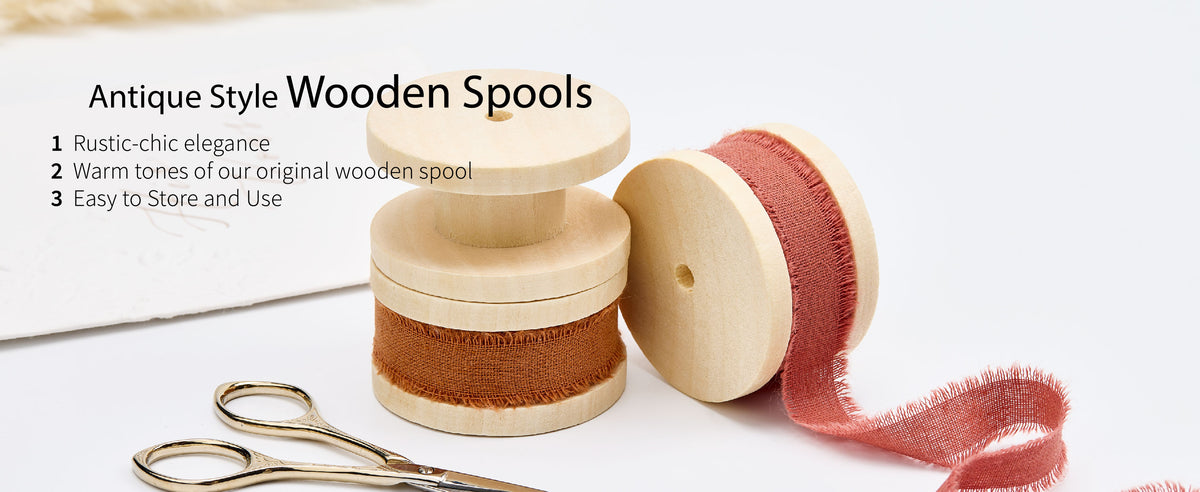 Brown and terracotta fringed cotton ribbon on pale wooden spools with gold-toned craft scissors.