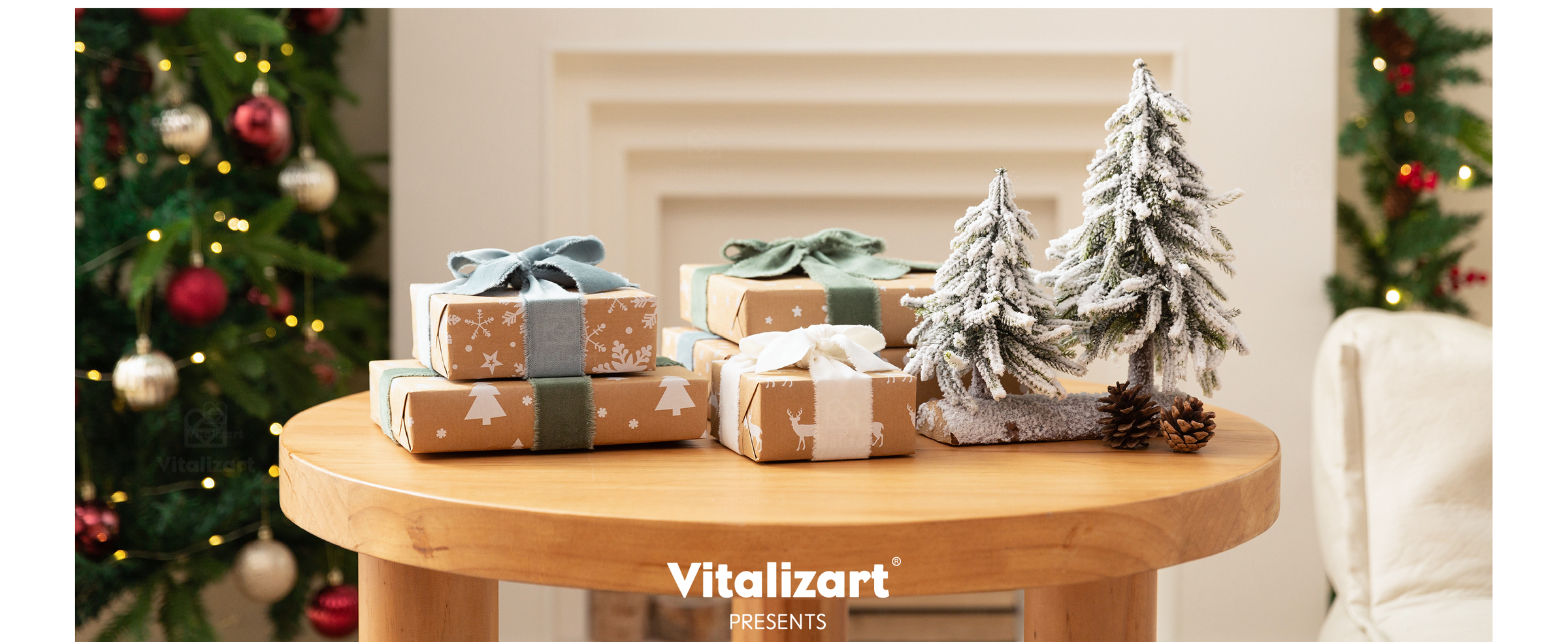 Holiday gifts tied with blue-gray, green, and ivory frayed ribbons beside miniature snowy trees