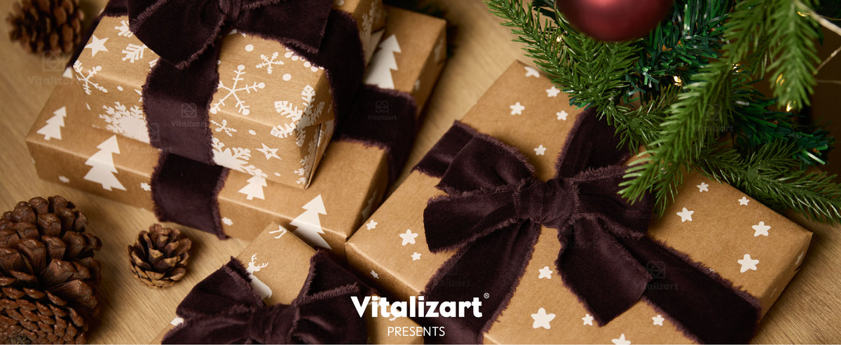 Christmas gifts tied with dark brown fringed velvet ribbon beneath ornaments and evergreen branches.