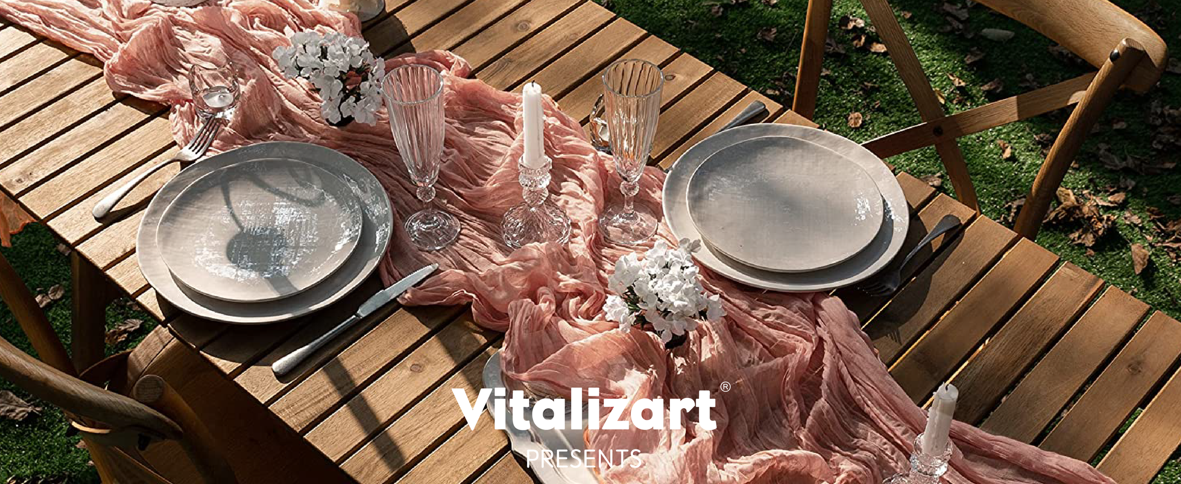 Peach cheesecloth table runner draped across an outdoor table set with plates, flowers, and candles