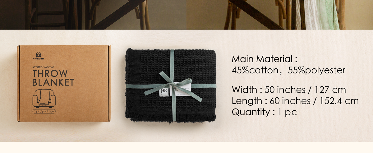 Folded black waffle-weave throw with fringe, packaging, and 50 by 60 inch specifications