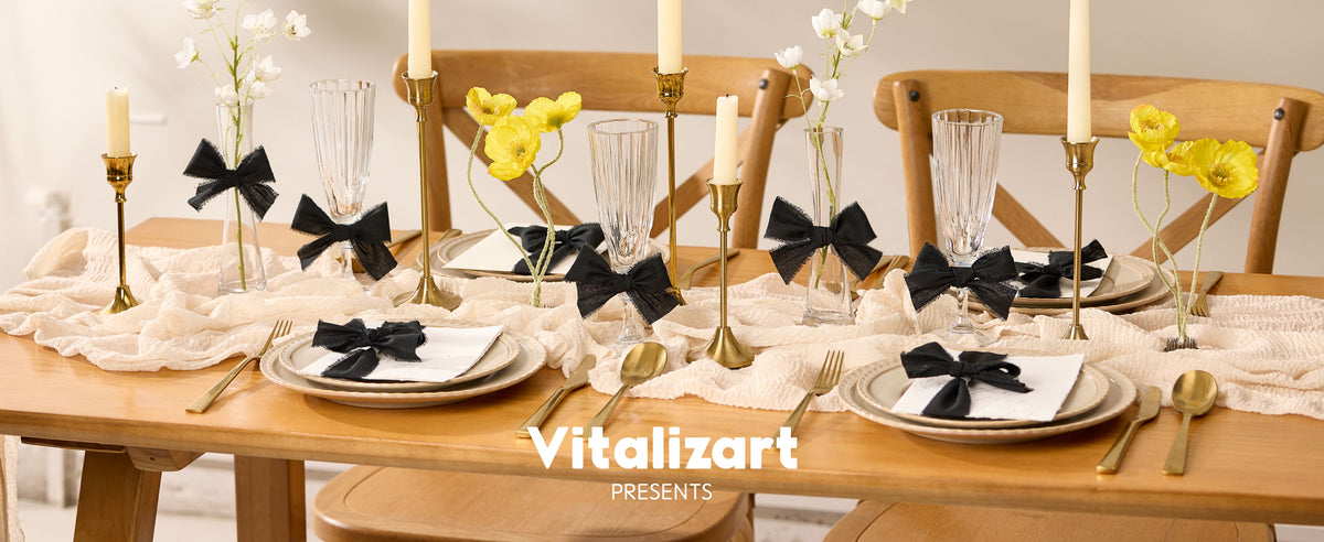 Black frayed cotton ribbon bows decorate glasses, vases, and place settings on an elegant floral dining table
