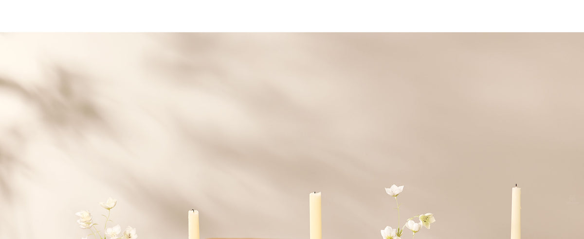 White frayed cotton ribbon tied into decorative bows on a flower vase and in a woman's brown updo.