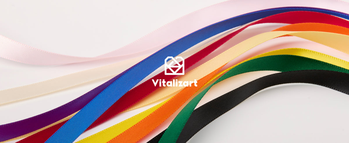 Glossy narrow satin ribbons in rainbow colors sweep diagonally across a white background