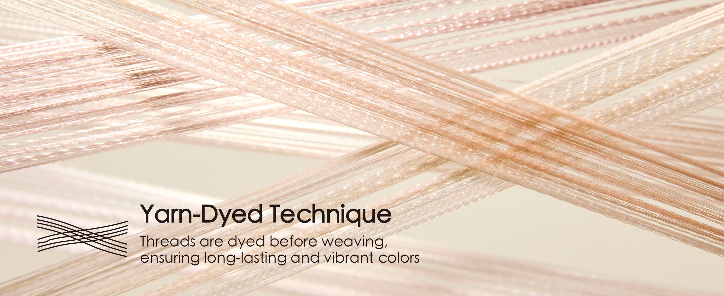 Close-up of pale blush satin threads crossing to show the ribbon's fine woven, glossy texture.
