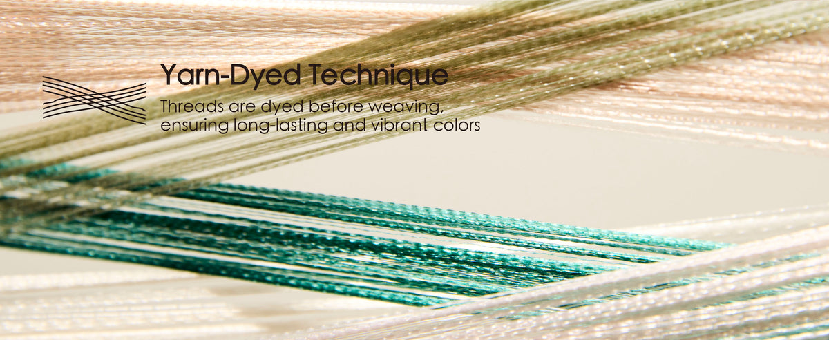 Close-up of blush, cream, olive, and teal ribbon threads crossing to show yarn-dyed weaving.