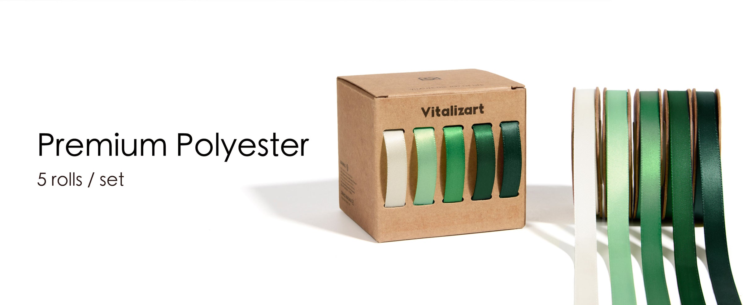 Five cream-to-dark-green satin ribbon rolls beside a kraft cardboard dispenser box