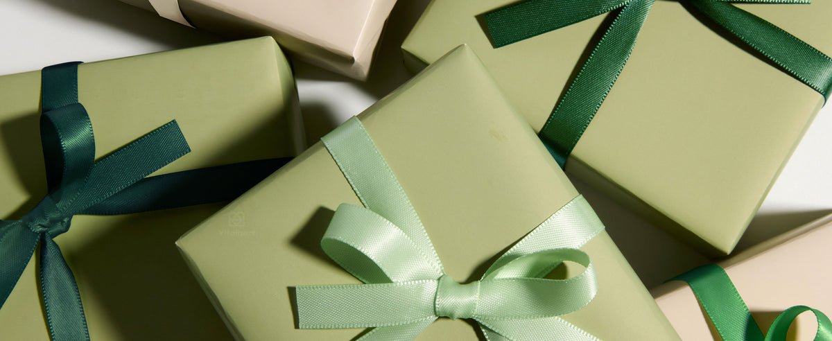 Pastel gift boxes wrapped with glossy white, mint, and green satin ribbon bows