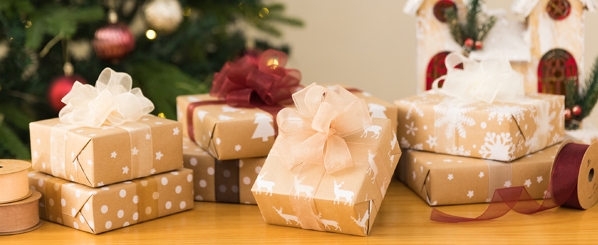 Christmas presents decorated with cream, peach, burgundy, and taupe sheer organza ribbon bows