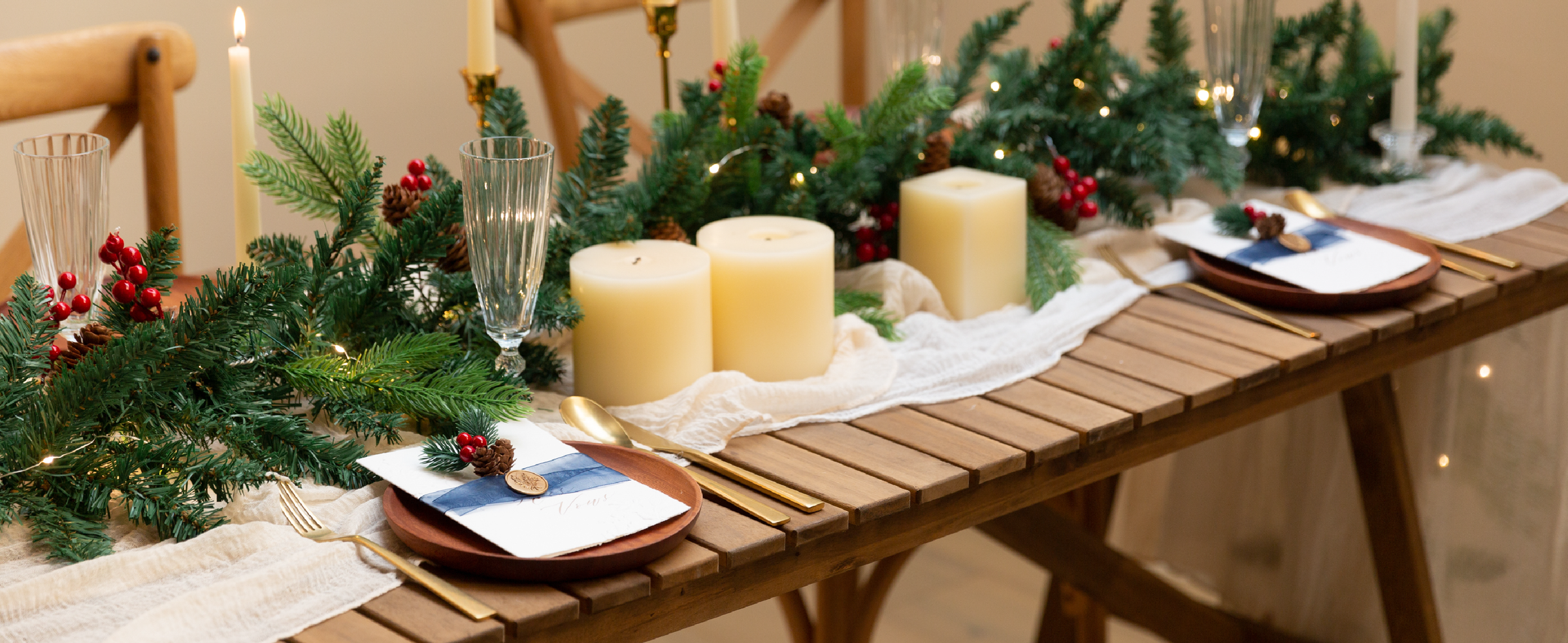 Navy sheer organza ribbon accents place cards on a candlelit holiday dining table.