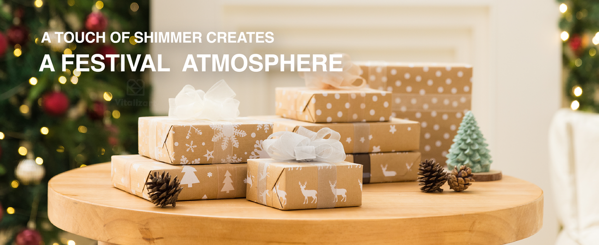 White, cream, and gray organza ribbon bows decorate stacked kraft gifts by a Christmas tree.