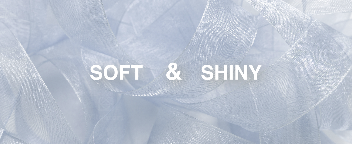 Close-up of light blue sheer organza ribbon showing its soft, translucent weave and subtle shine