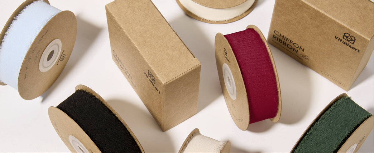 Assorted spools of frayed chiffon ribbon in red, black, green, blue, ivory and pink