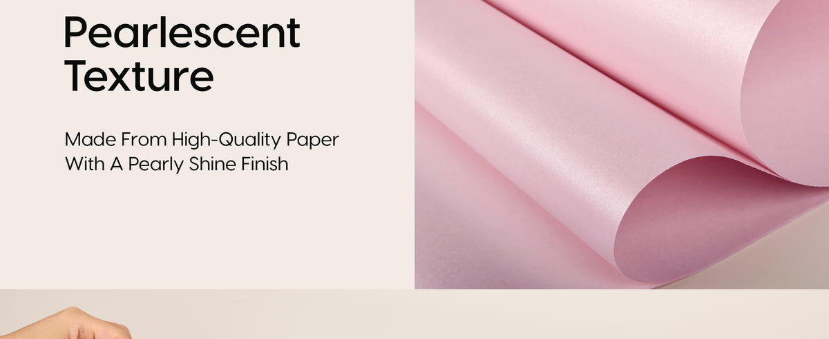Close-up of blush pink wrapping paper showing its smooth pearlescent texture