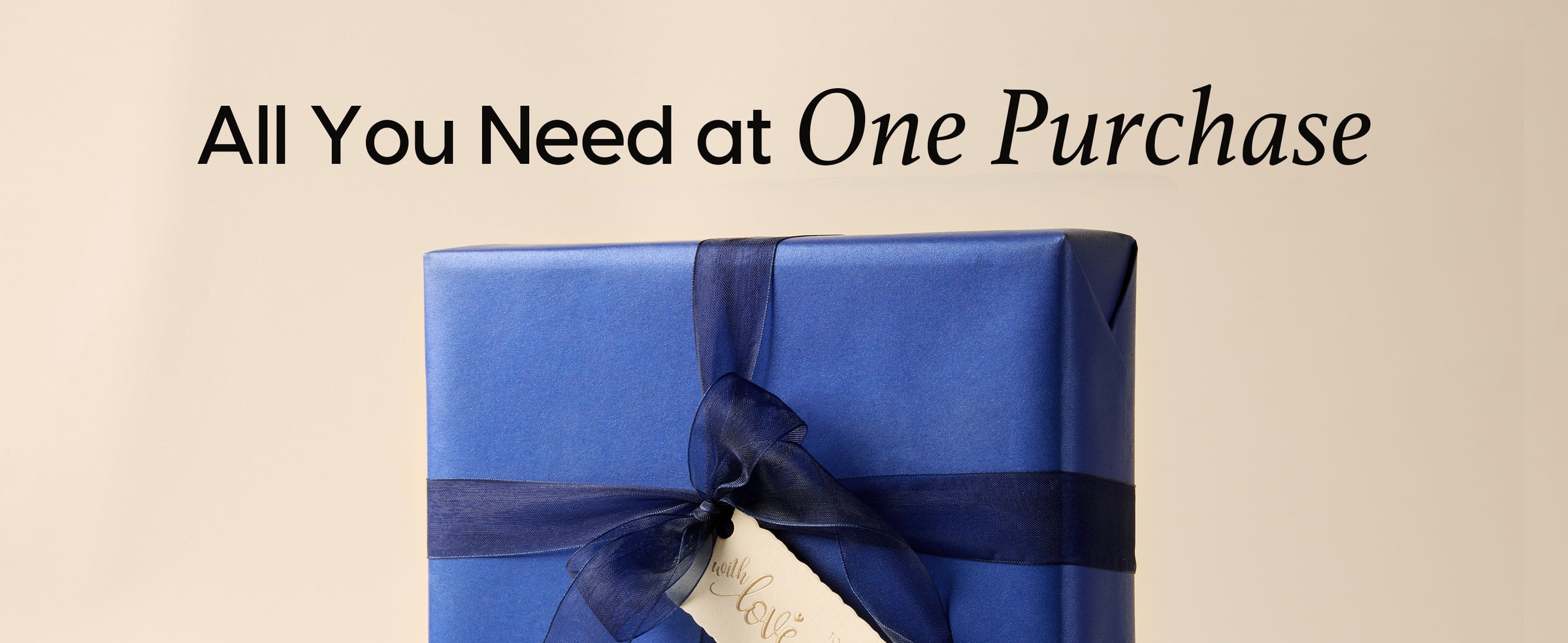 Lustrous blue wrapped gift finished with dark navy organza ribbon and a cream tag