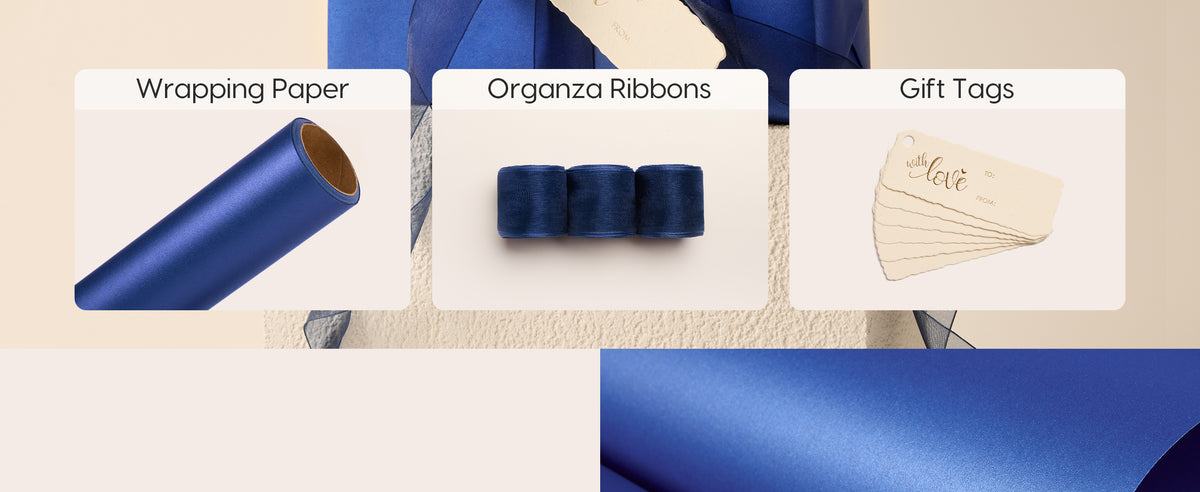 Blue pearly wrapping set with a paper roll, three navy organza ribbons, and cream gift tags