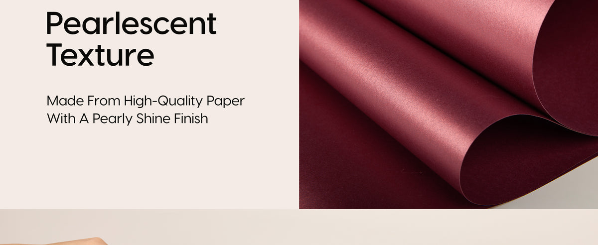 Close-up of curled burgundy wrapping paper with a smooth, fine pearlescent sheen.