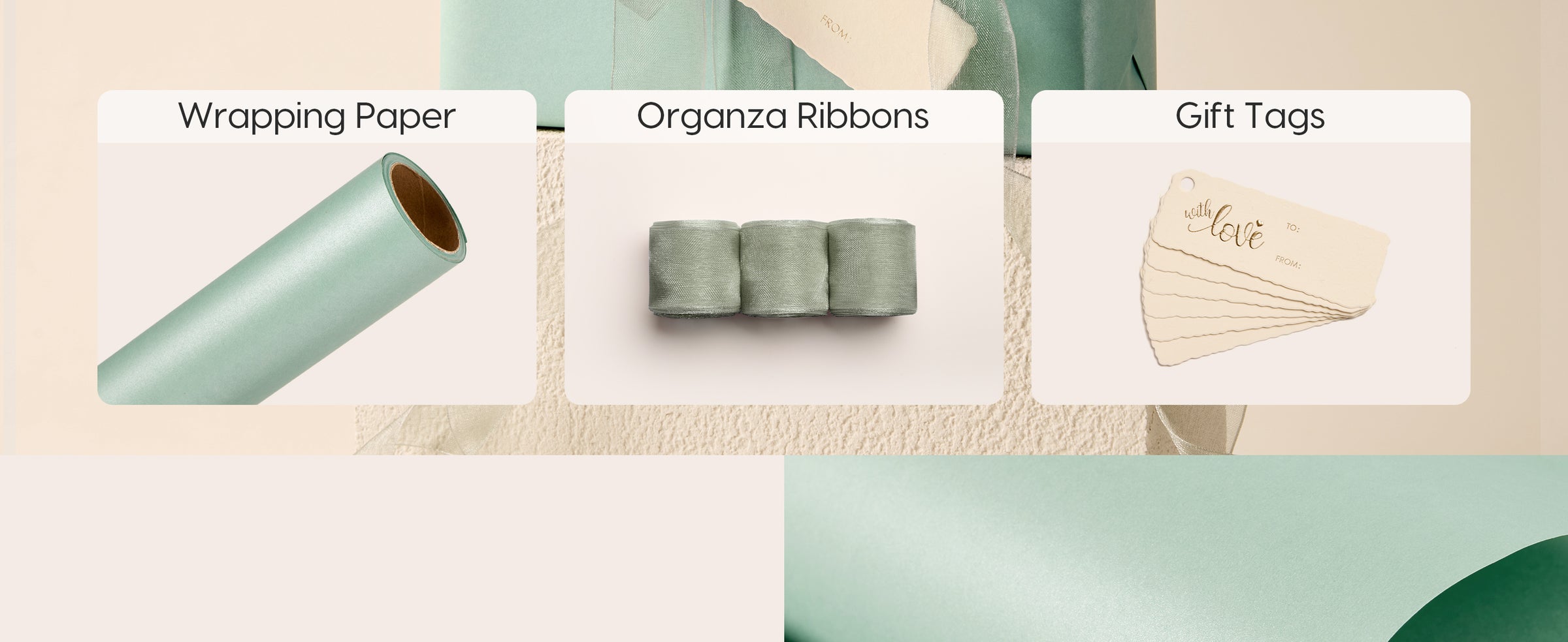 Sage pearlescent wrapping paper set with organza ribbons, gift tags, and a wrapped box.