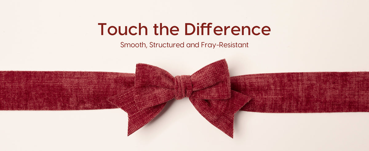Close-up of a structured red velvet ribbon bow with a plush, finely ribbed texture.