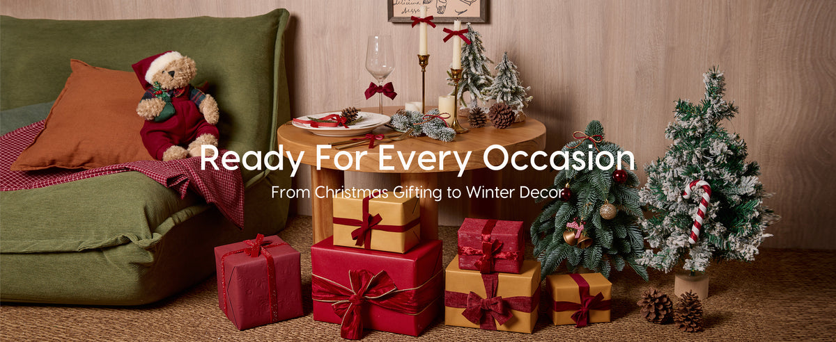 Red velvet ribbons decorate Christmas gifts, candles, tableware and greenery in a festive room.