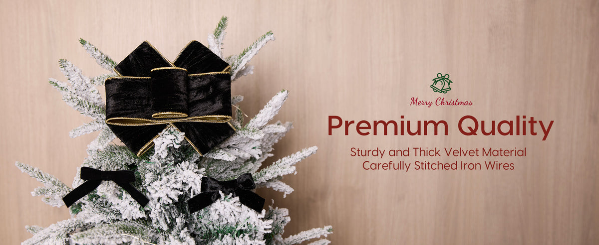Black velvet wired ribbon forms a large gold-edged bow and two smaller bows on a snowy tree.