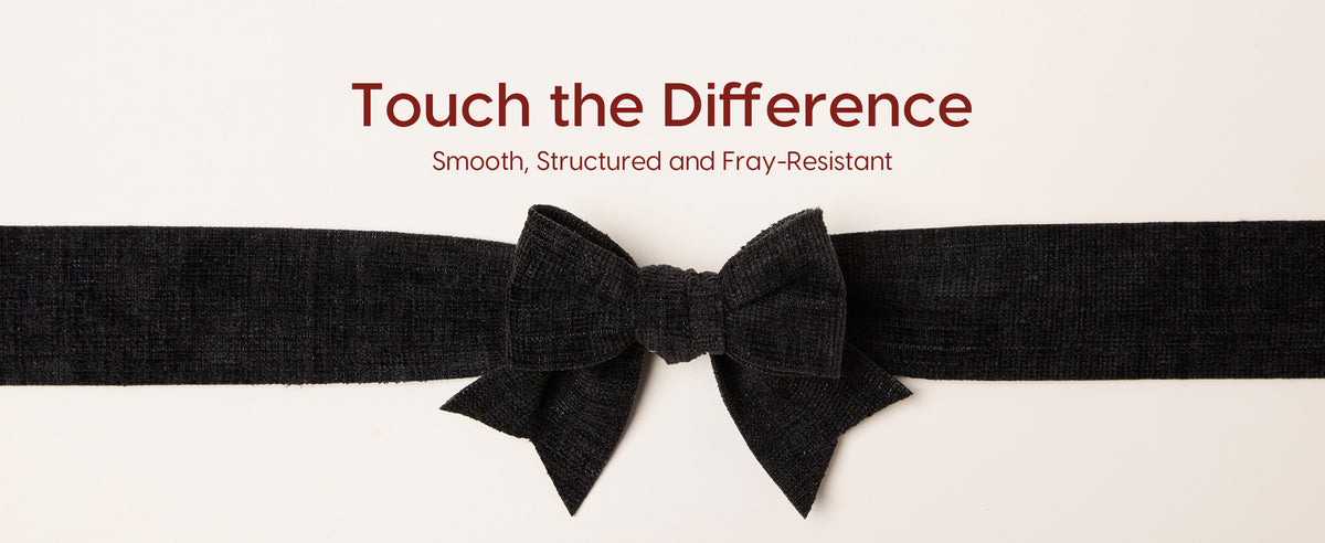 Close-up of a structured black velvet ribbon bow with a plush, finely ribbed texture.