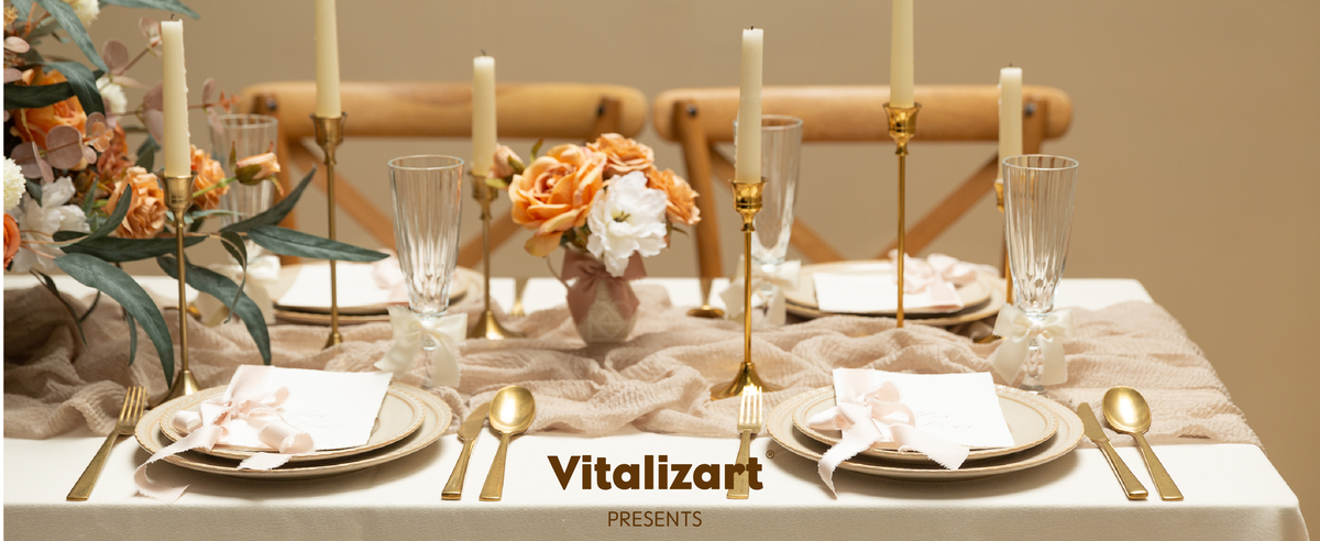 Cream-white satin ribbon bows decorate glasses and place settings on an elegant candlelit dining table.