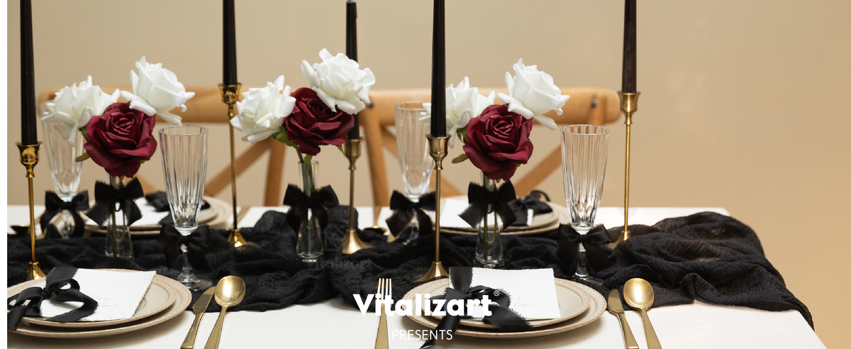 Black ribbon bows decorate glasses, flowers, and place settings on an elegant dining table