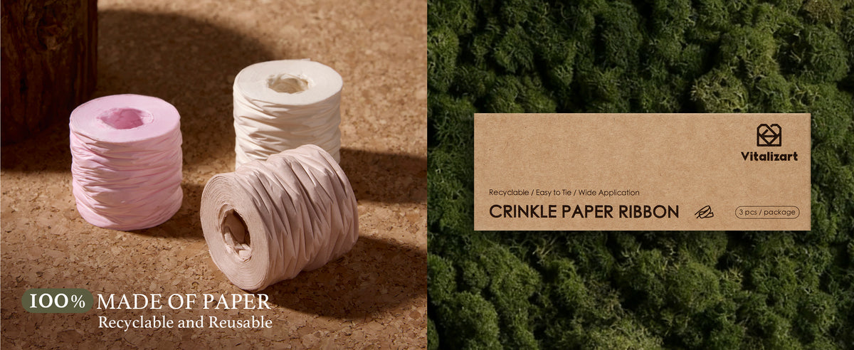 Pink, white, and nude crinkle paper ribbon rolls beside kraft packaging on moss