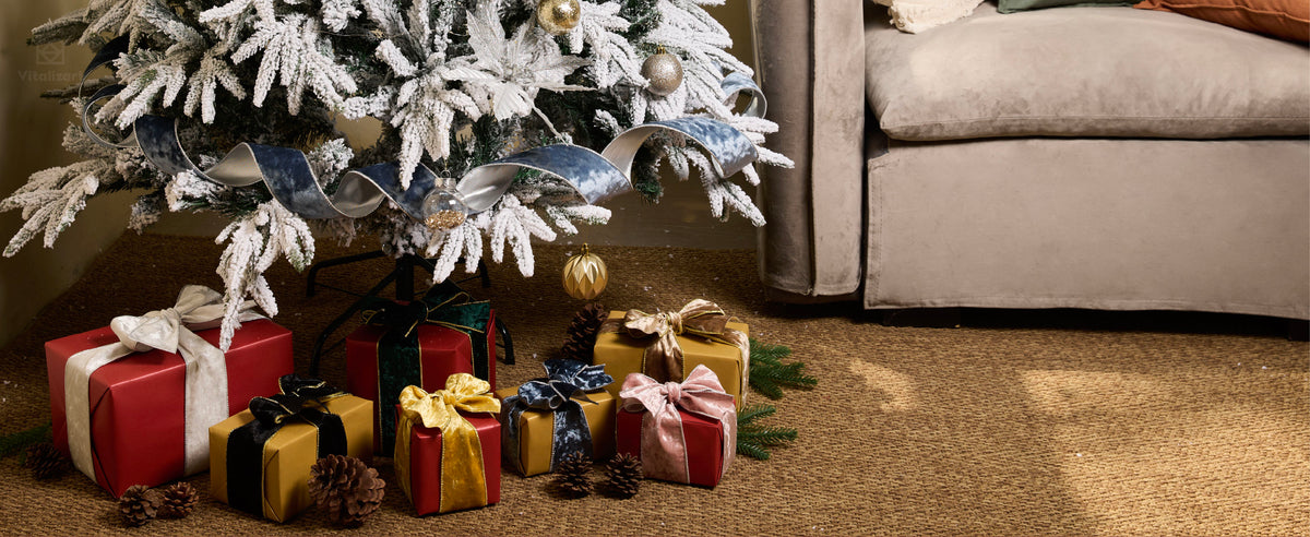 Large dusty blue wired velvet bow with silver edging on a flocked Christmas tree