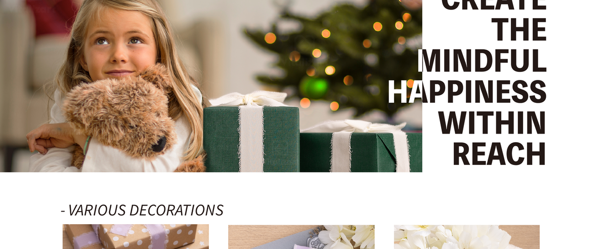 Girl hugging a teddy bear beside a green gift wrapped with a wide pale chiffon ribbon