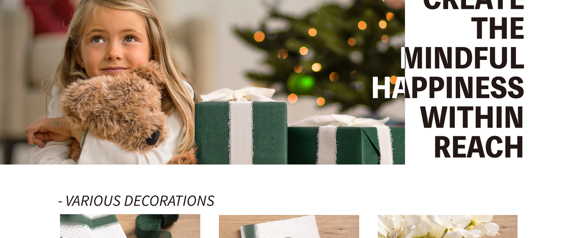 Girl hugging a teddy bear beside a green gift wrapped with a wide pale chiffon ribbon
