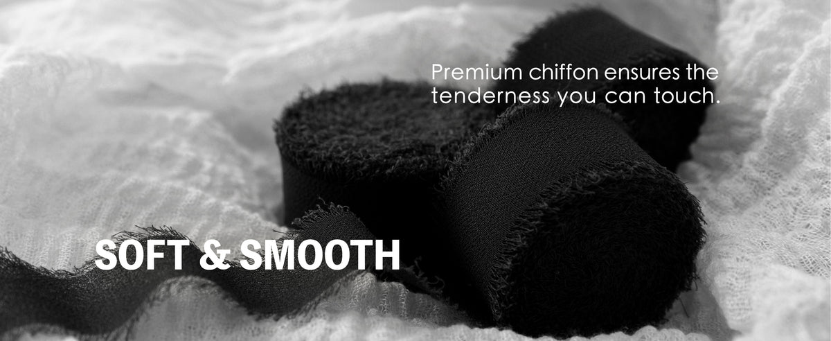 Black chiffon ribbon rolls and loose sheer ribbon with soft, frayed edges on pale fabric
