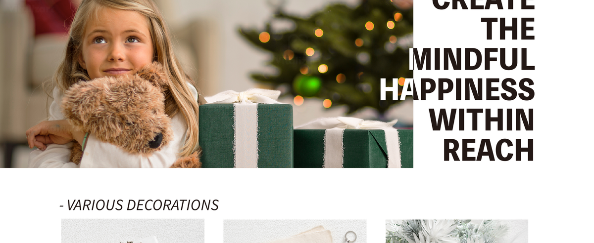 Girl hugging a plush dog beside a green gift box wrapped with white chiffon ribbon