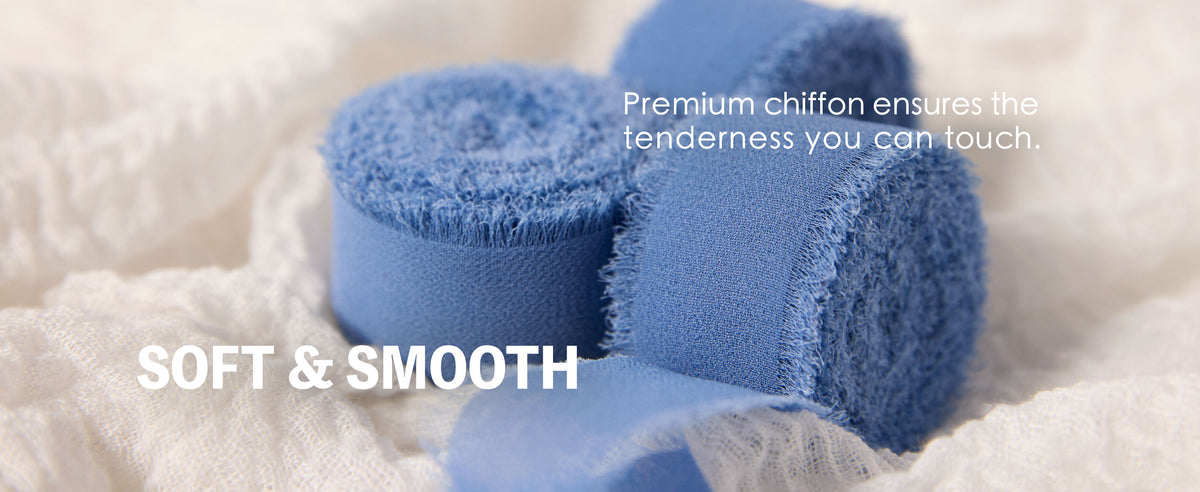 Close-up of dusty blue chiffon ribbon rolls with fine woven texture and soft frayed edges.
