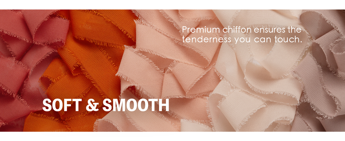 Close-up of layered burgundy, orange, peach, and ivory chiffon ribbons with frayed edges